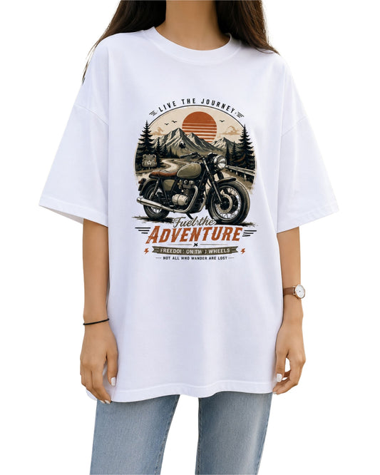 Vintage motorcycle graphic T-shirt design with a classic bike, mountain road, retro sunset, pine trees and distressed adventure typography in earthy vintage colours white