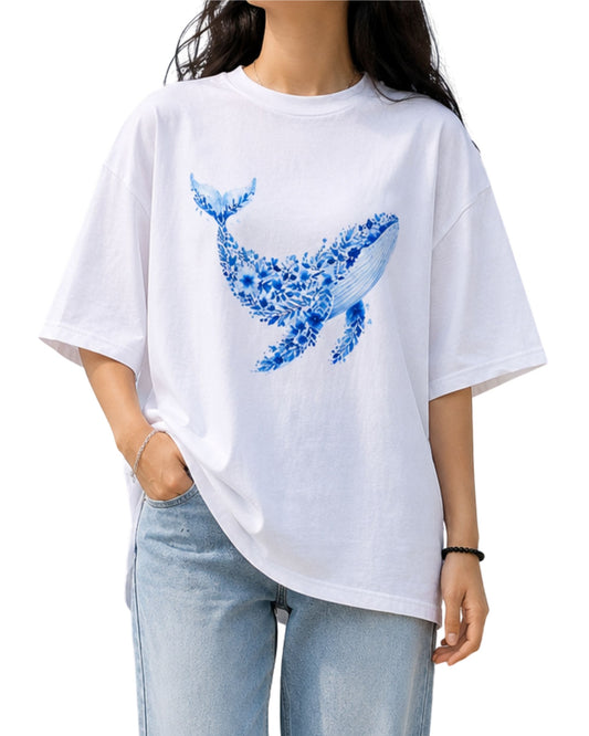 floral whale illustration printed on a white oversized T-shirt, featuring intricate botanical and ocean-inspired details in vibrant shades.
