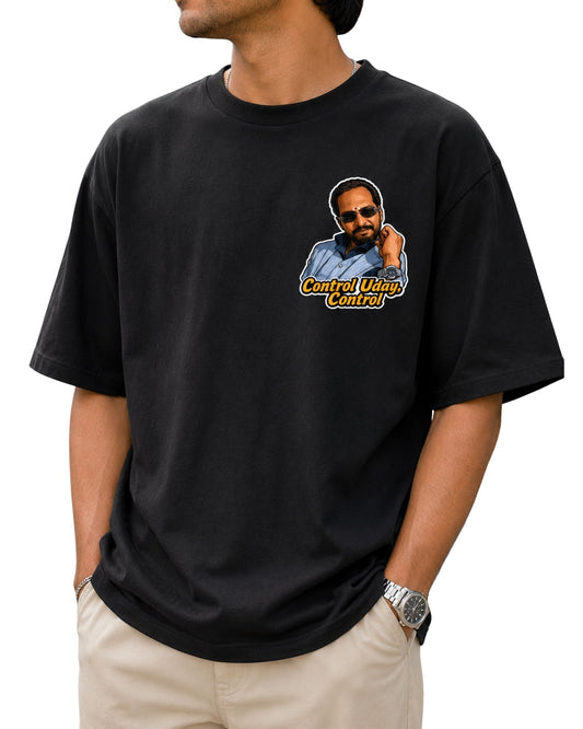 Black oversized T-shirt featuring a bold illustrated “Control Uday, Control” graphic with a stylish man wearing sunglasses and a suit, finished with typography and a outline.