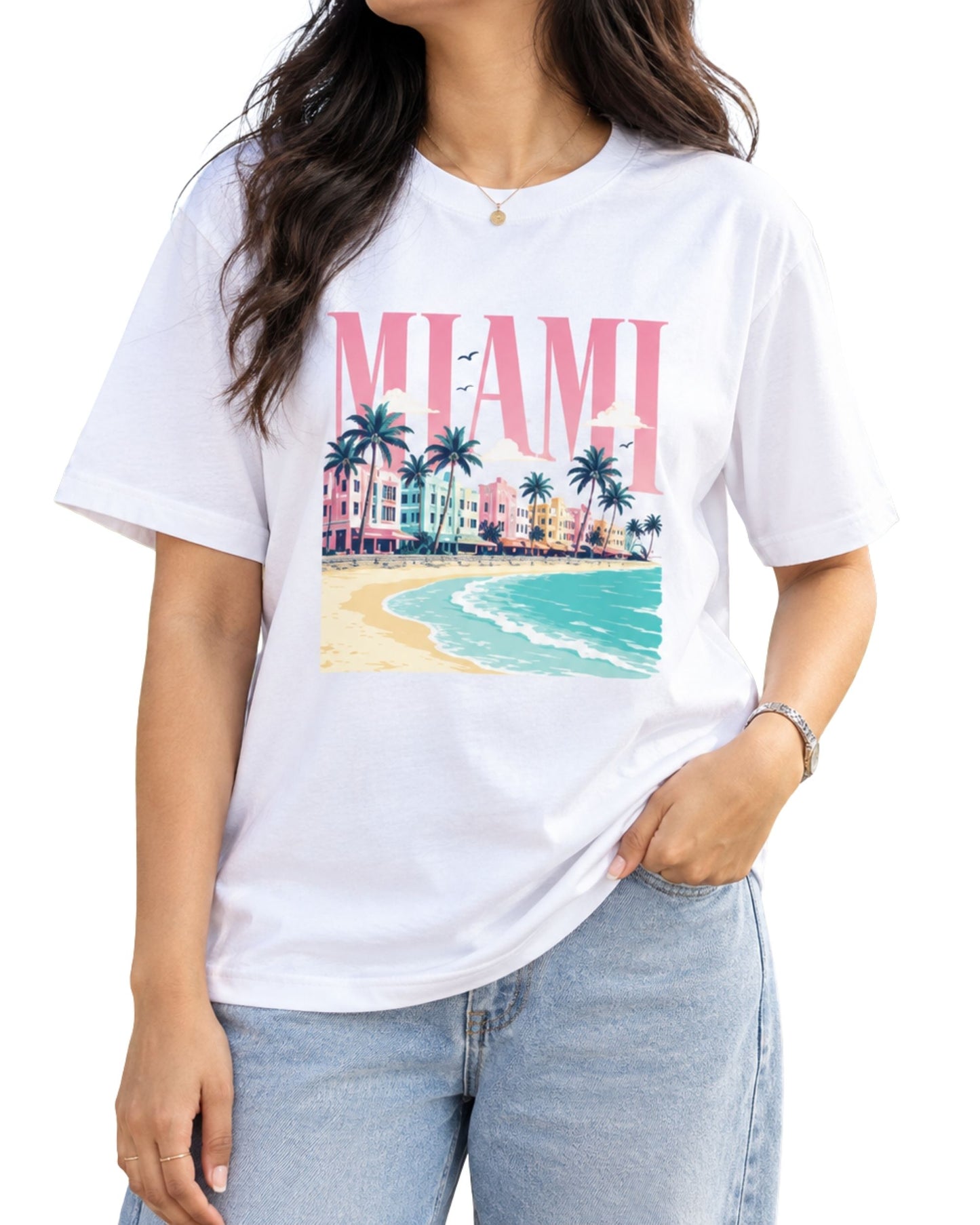 Graphic T-shirt with a vibrant Miami beach design, featuring bold “MIAMI” typography, palm trees, colorful coastal architecture, sandy shoreline, and ocean waves white