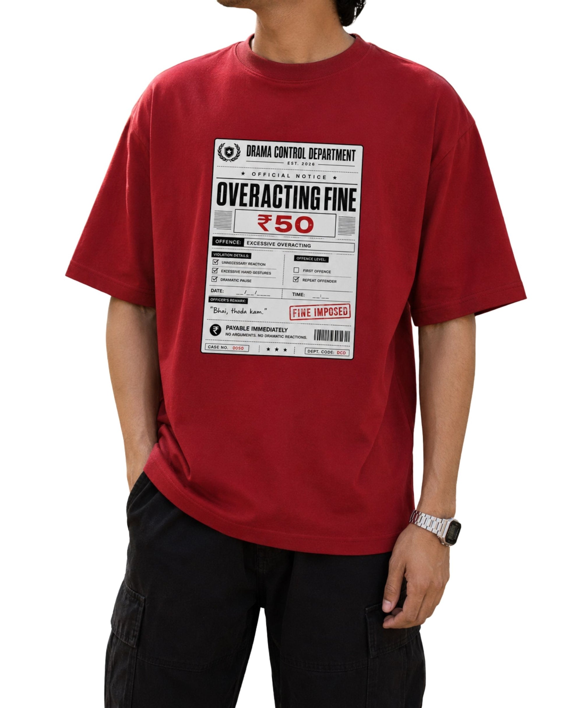 Model wearing a red oversized graphic T-shirt with a “Drama Control Department – Overacting Fine ₹50” print, styled with cargo pants.