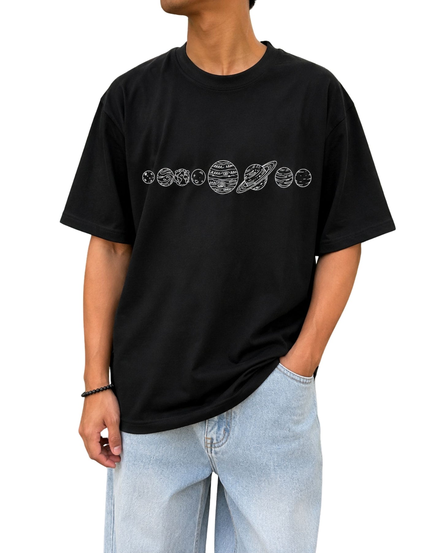 Black oversized T-shirt featuring a minimalist hand-drawn solar system and planets graphic across the chest.