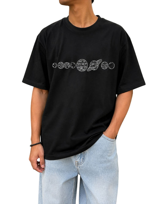 Black oversized T-shirt featuring a minimalist hand-drawn solar system and planets graphic across the chest.