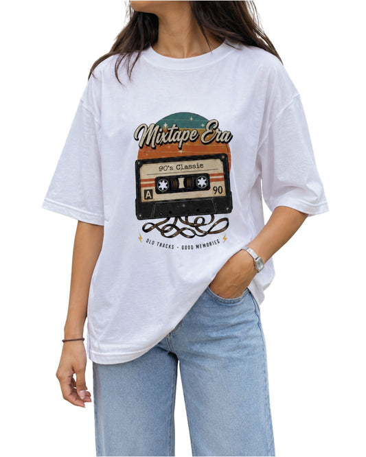 Vintage cassette tape graphic with “Mixtape Era” typography, retro sunset colors, and “Old Tracks, Good Memories” text on a white T-shirt.