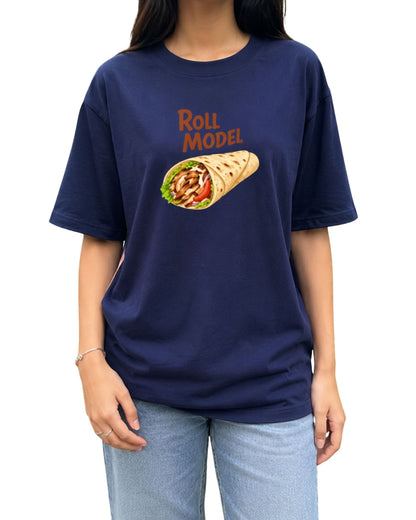 royal blue oversized T-shirt featuring a playful “Roll Model” graphic above a colorful illustrated wrap, styled on a young female model in an outdoor setting.