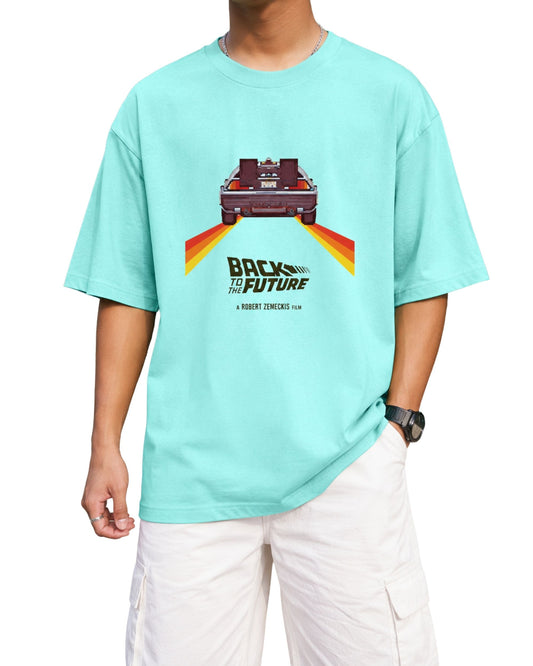 Mint oversized T-shirt with a retro pixel-style car graphic, colorful speed trails, and bold “Back to the Future” inspired typography printed on the front.