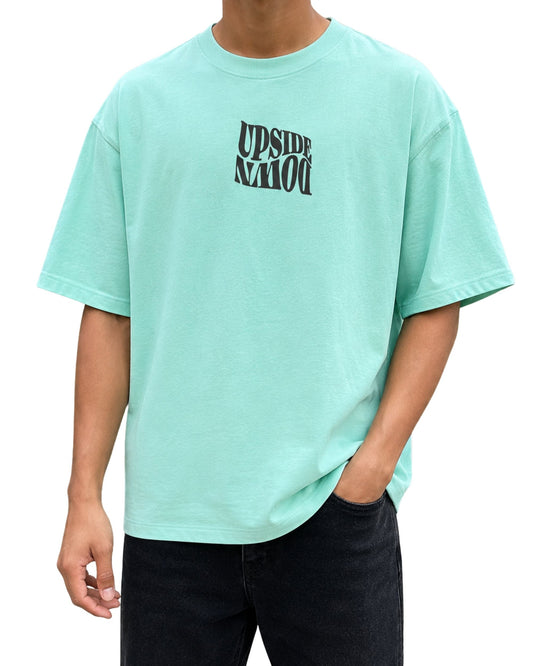 Oversized T-shirt with a bold “Upside Down” warped typography graphic printed on the front chest Mint