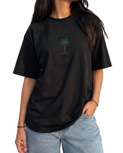 Minimal palm tree graphic T-shirt design with leaves and trunk in a clean tropical line art style black