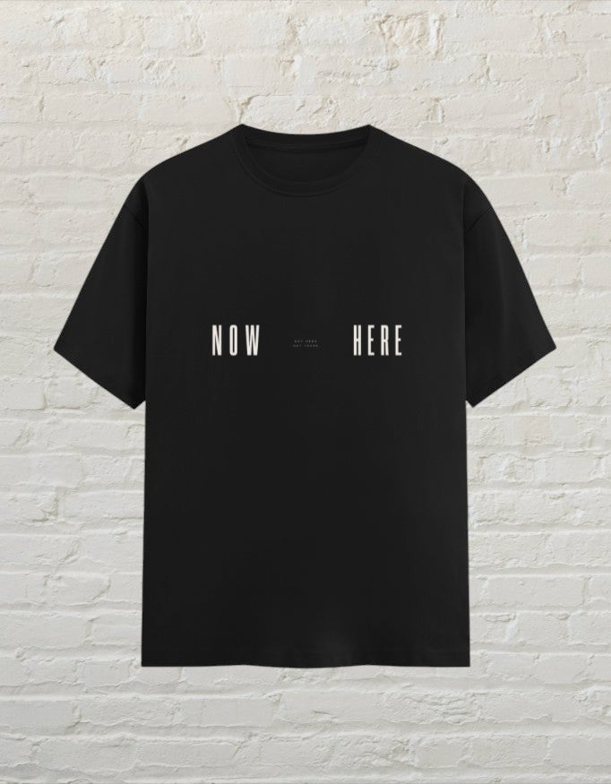 CoreTeez black unisex cotton t-shirt featuring a minimalist Now Here graphic print.