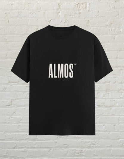 CoreTeez black unisex crew neck t-shirt made of 100% cotton featuring a minimalist ALMOST graphic print.