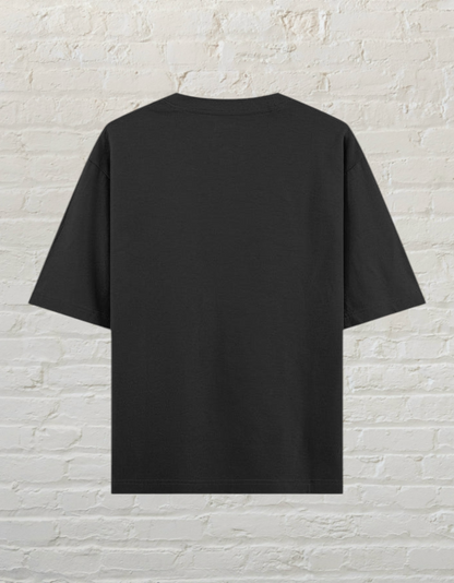 Back view of a plain black CoreTeez unisex oversized cotton t-shirt against a
