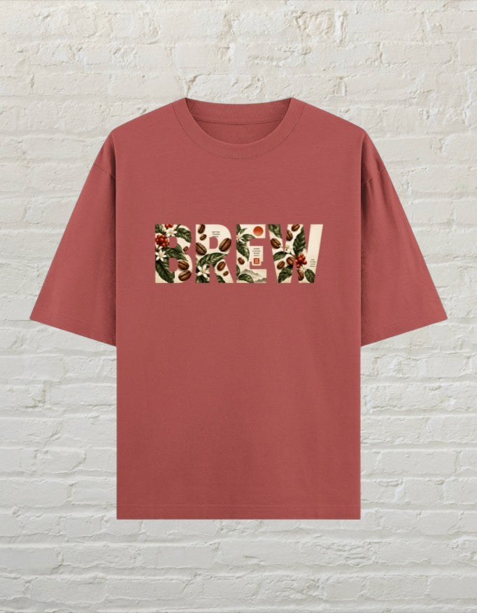 CoreTeez oversized cotton t-shirt in coral featuring a botanical coffee-themed graphic print on the front.