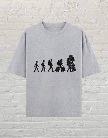 CoreTeez grey melange oversized cotton t-shirt featuring a graphic of a traveler accumulating luggage.