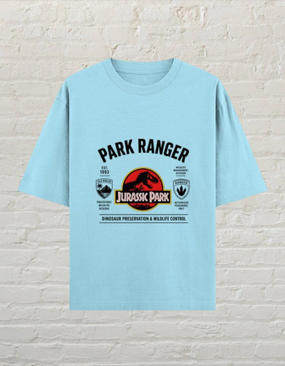 CoreTeez baby blue oversized cotton t-shirt featuring a Jurassic Park dinosaur ranger graphic print.