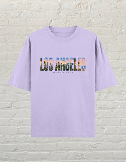 CoreTeez lavender oversized cotton t-shirt featuring a Los Angeles cityscape graphic print on the chest
