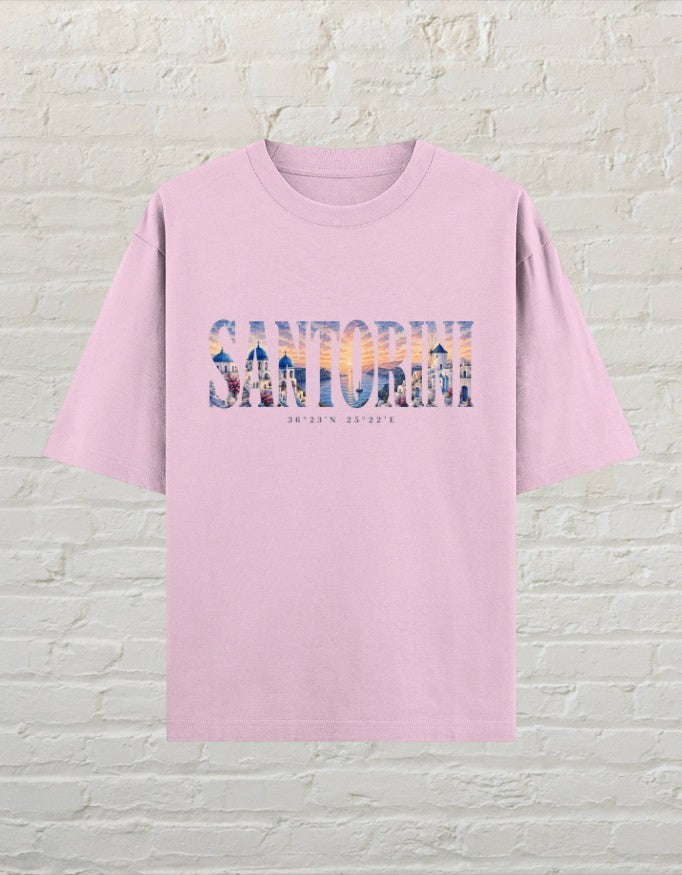 CoreTeez light baby pink oversized cotton t-shirt featuring a Santorini travel graphic print on the front.