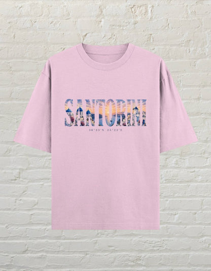 CoreTeez light baby pink oversized cotton t-shirt featuring a Santorini travel graphic print on the front.