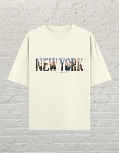 CoreTeez oversized off white cotton t-shirt featuring a New York cityscape graphic print with coordinates.