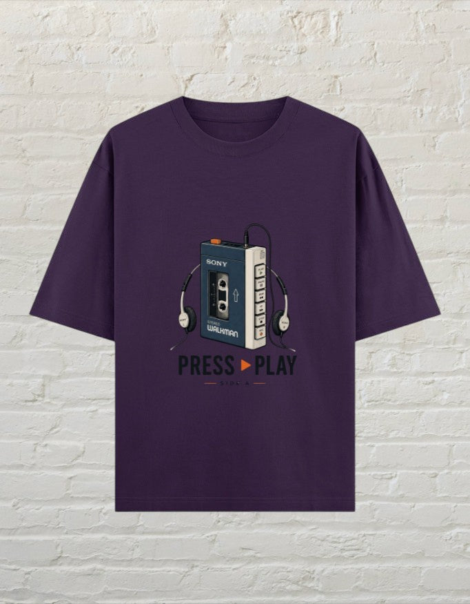 CoreTeez unisex oversized purple cotton t-shirt featuring a vintage Sony Walkman graphic and Press Play text