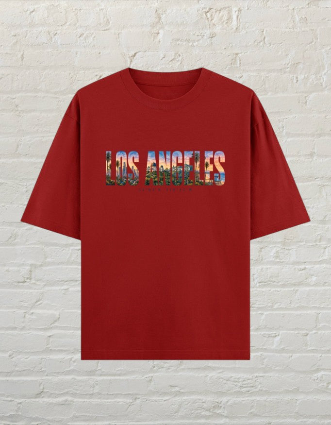 CoreTeez unisex oversized red cotton t-shirt featuring a Los Angeles cityscape graphic print on the chest.