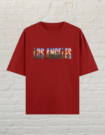 CoreTeez unisex oversized red cotton t-shirt featuring a Los Angeles cityscape graphic print on the chest.