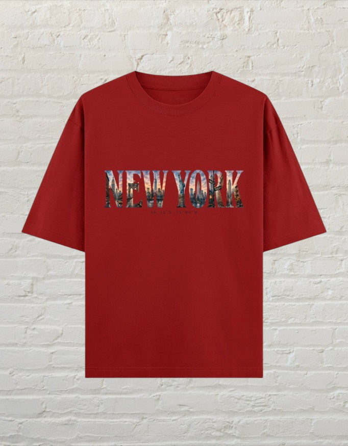 CoreTeez oversized red cotton t-shirt featuring a New York cityscape graphic print on the chest.
