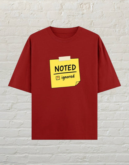 CoreTeez unisex oversized red cotton t-shirt featuring a yellow sticky note graphic that says Noted and Ignored.