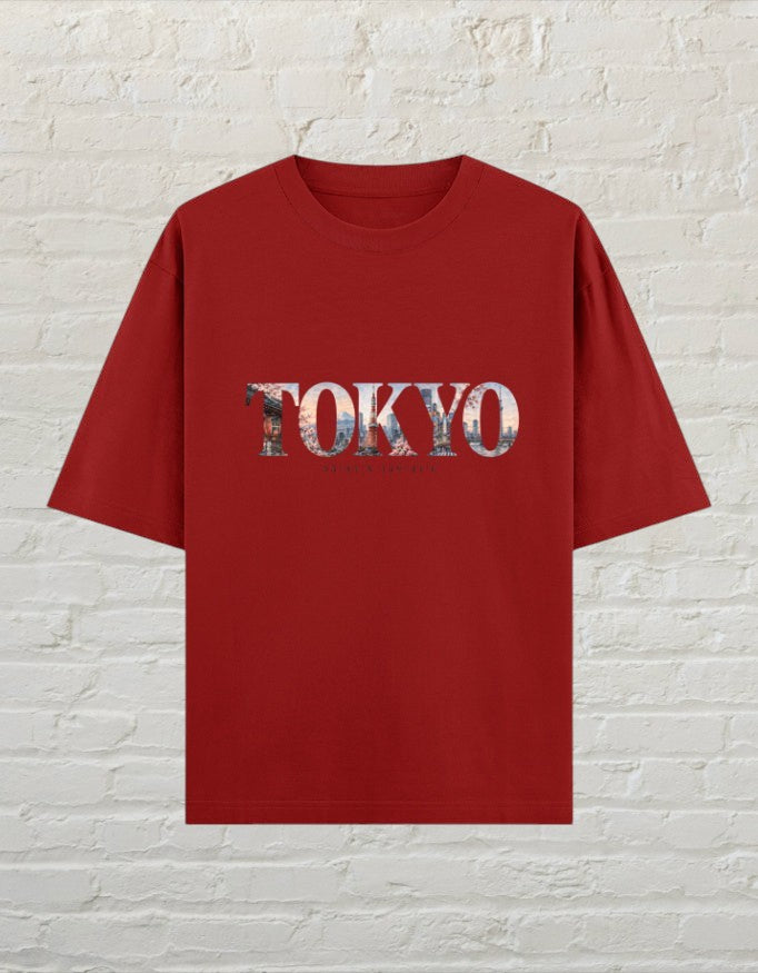 CoreTeez unisex oversized red cotton t-shirt featuring a Tokyo city skyline graphic print on the front.