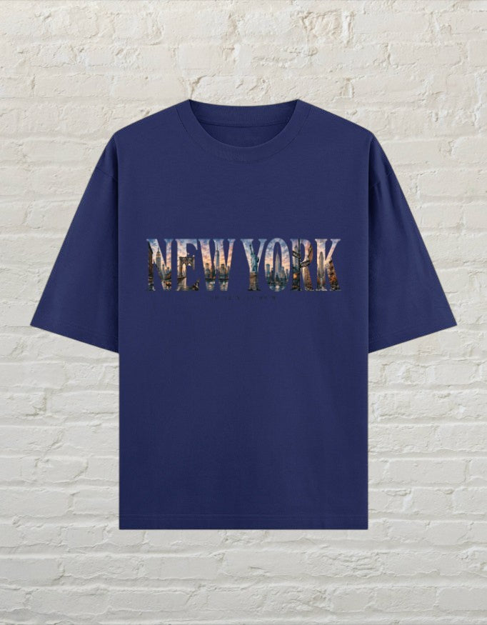 CoreTeez royal blue oversized cotton t-shirt featuring a New York cityscape graphic print on the front.
