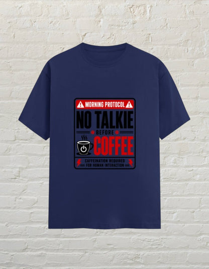 CoreTeez royal blue cotton unisex t-shirt featuring a No Talkie Before Coffee graphic print on a brick wall background.