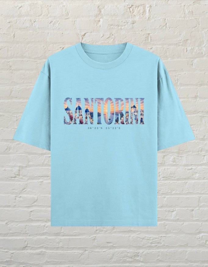 CoreTeez baby blue oversized cotton t-shirt featuring a Santorini travel graphic print on the front.
