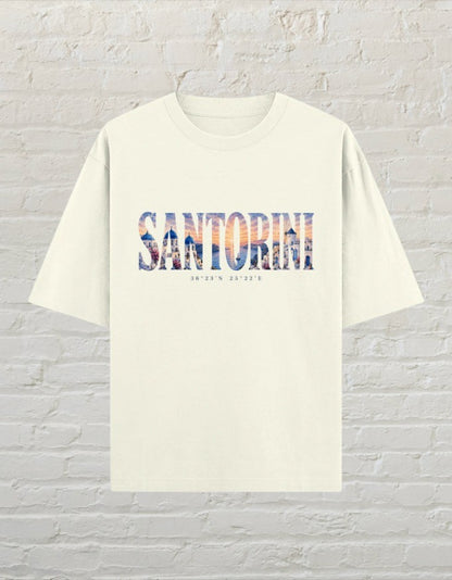 CoreTeez unisex oversized off white cotton t-shirt featuring a Santorini travel graphic print on the front.