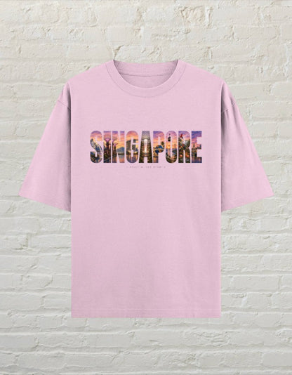 CoreTeez light baby pink oversized cotton t-shirt featuring a colourful Singapore cityscape graphic print on the chest.