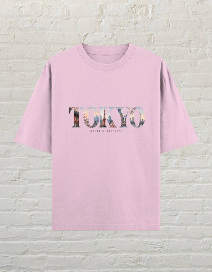 CoreTeez unisex oversized light baby pink cotton t-shirt featuring a Tokyo city graphic print with coordinates.