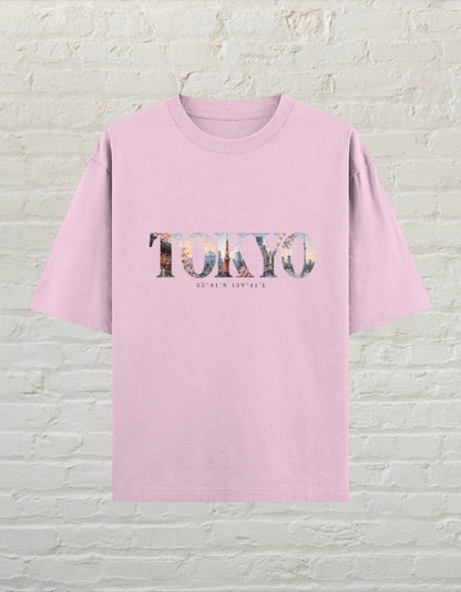 CoreTeez unisex oversized light baby pink cotton t-shirt featuring a Tokyo city graphic print with coordinates.