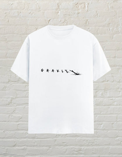 CoreTeez white unisex cotton graphic t-shirt featuring a minimalist Gravity text design on a brick wall background