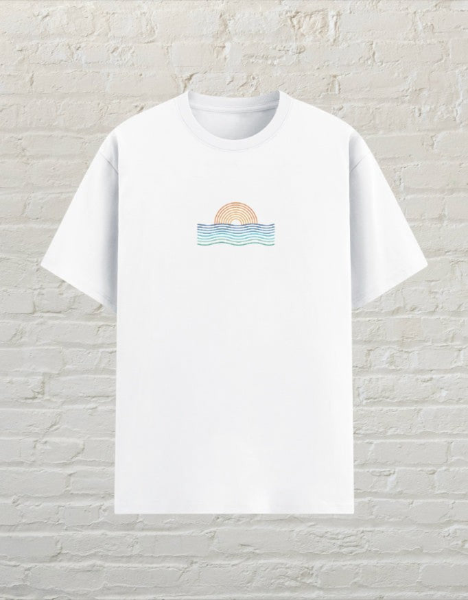 CoreTeez white unisex poly-cotton graphic t-shirt featuring a minimalist sunset and ocean wave design on the chest.
