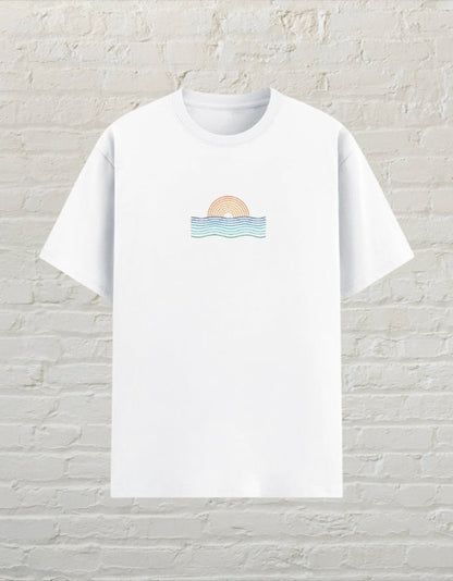CoreTeez white unisex poly-cotton graphic t-shirt featuring a minimalist sunset and ocean wave design on the chest.